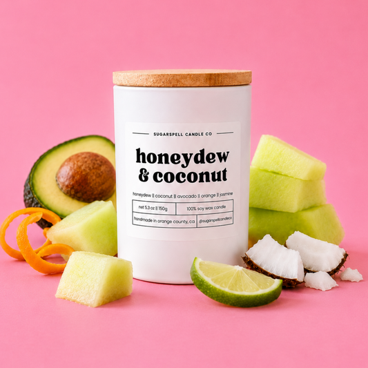Handmade Honeydew & Coconut soy candle in a white jar with melon and coconut