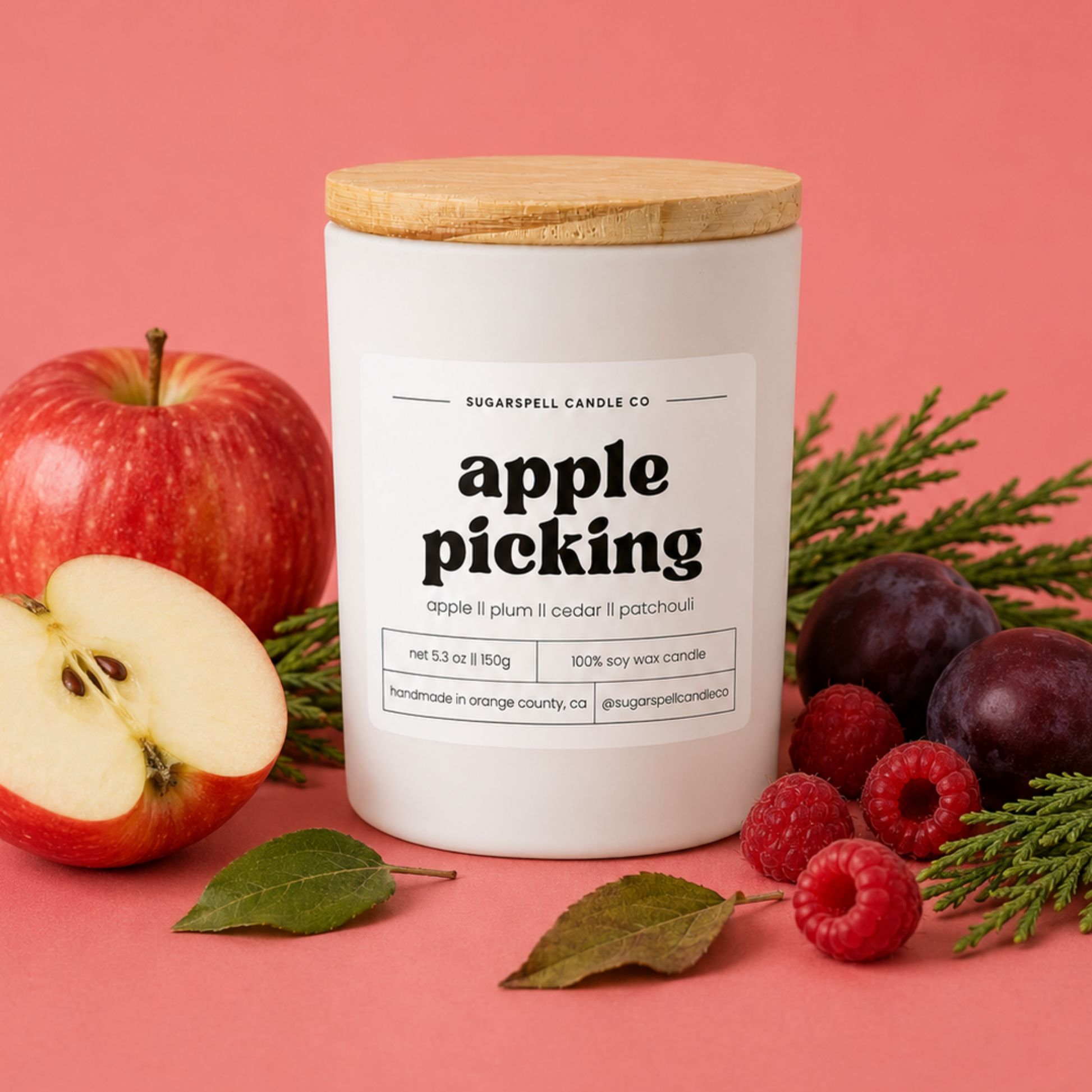 Handmade Apple Picking soy candle in a white glass jar with fresh apples and cedar