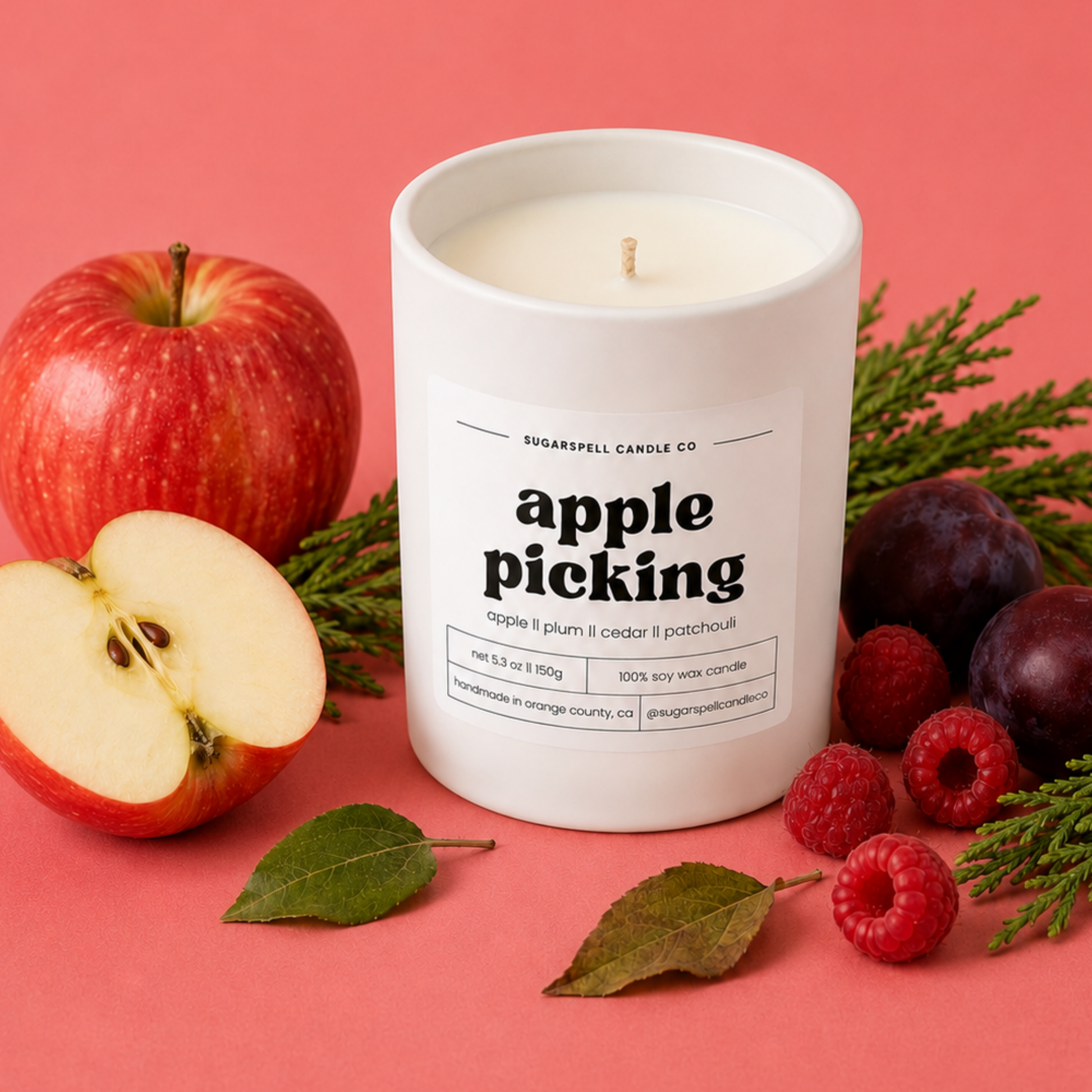 Handmade Sugarspell Apple Picking candle styled with orchard fruit and autumn leaves
