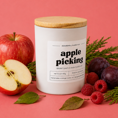 Handmade Apple Picking candle in an open white jar with plums and raspberries