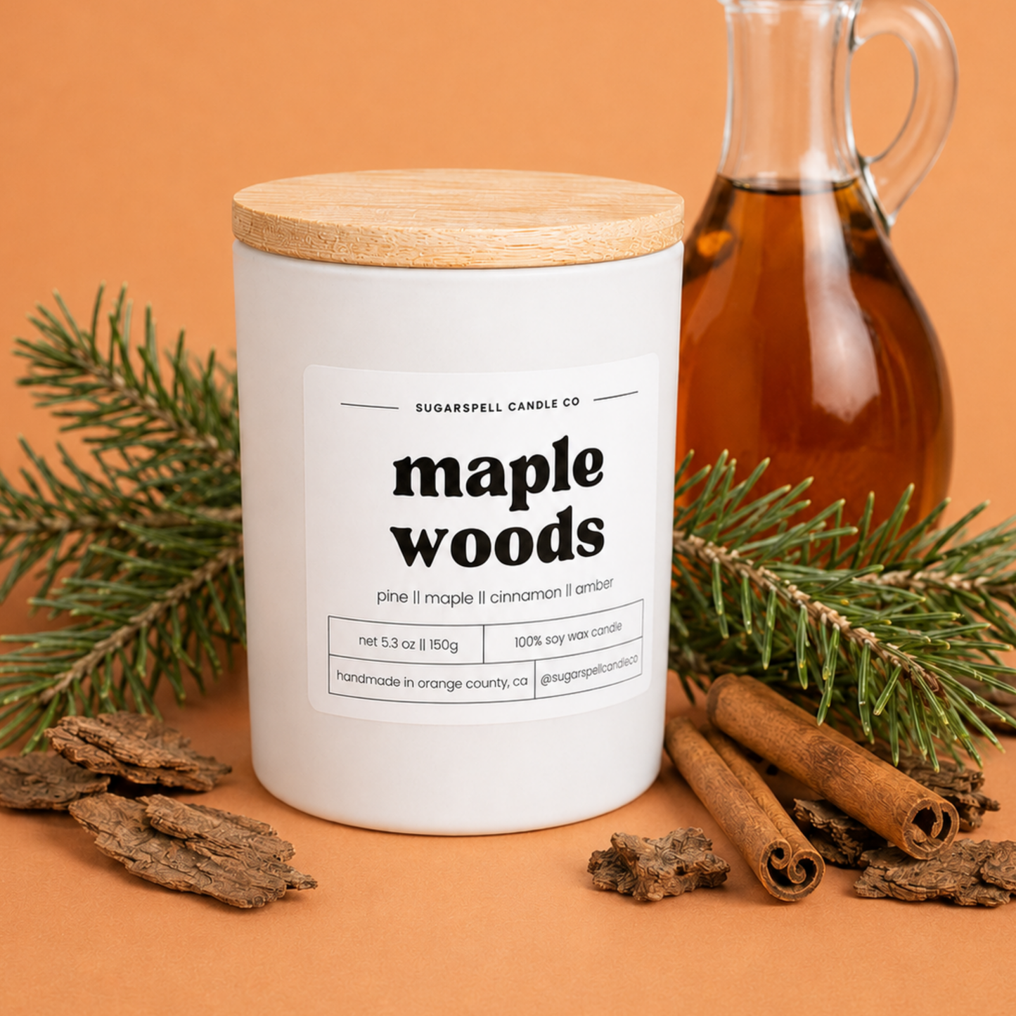 Handmade Sugarspell Maple Woods candle styled with maple syrup and cinnamon sticks