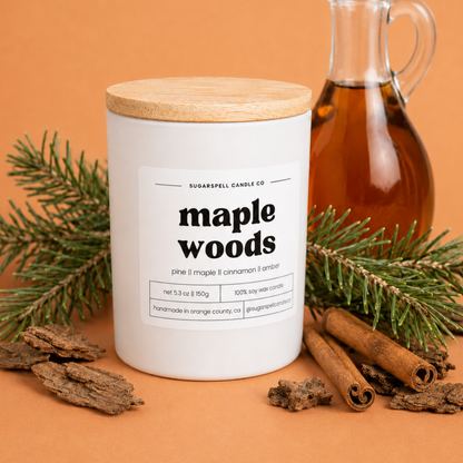 Handmade Sugarspell Maple Woods candle styled with maple syrup and cinnamon sticks