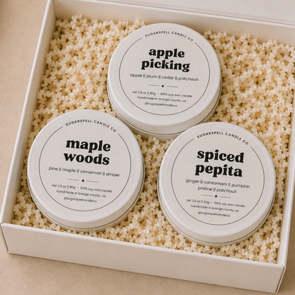 Open Scenic Route gift box with three handmade mini candle tins nestled in crinkle paper