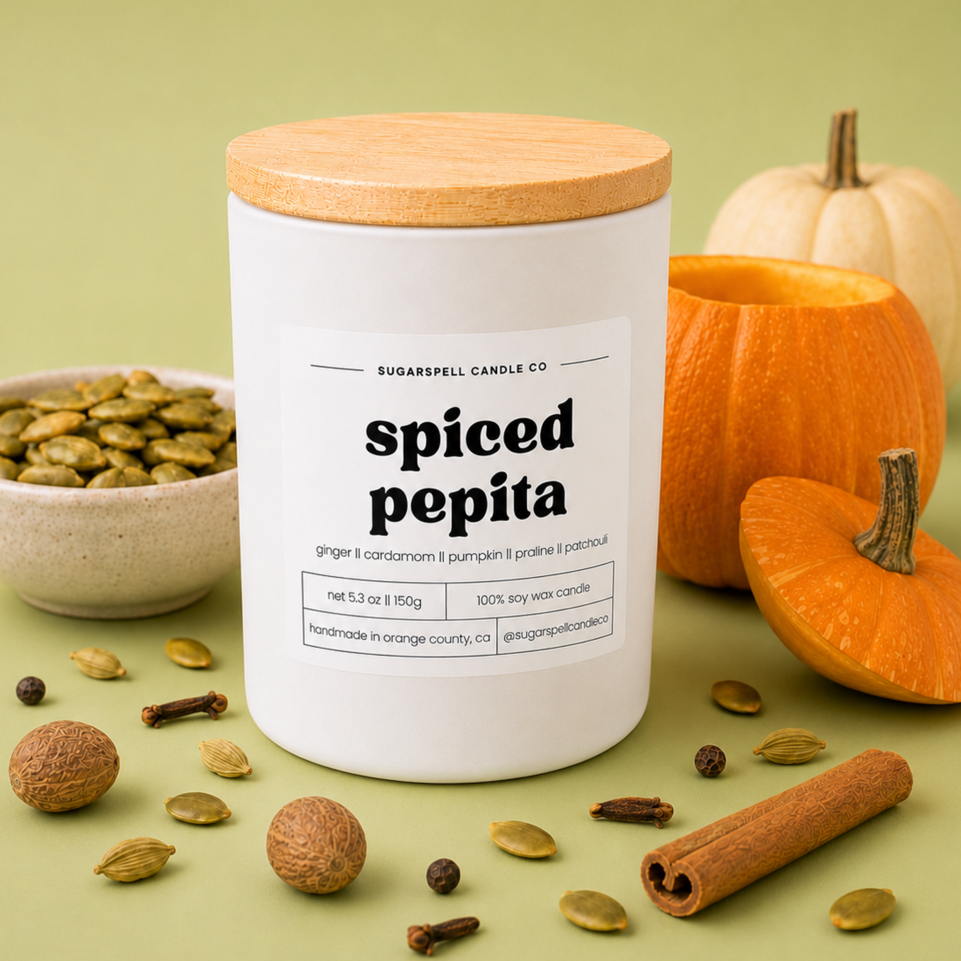 Handmade Sugarspell Spiced Pepita candle styled with a mini pumpkin and warm spices