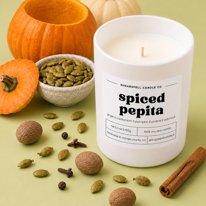 Handmade Spiced Pepita candle in an open white jar with toasted pepitas and cardamom